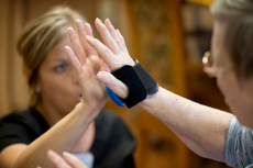 Certified occupational therapy assistant Rachel Beber helps Lois Roberts, 81, with metronome exercise.